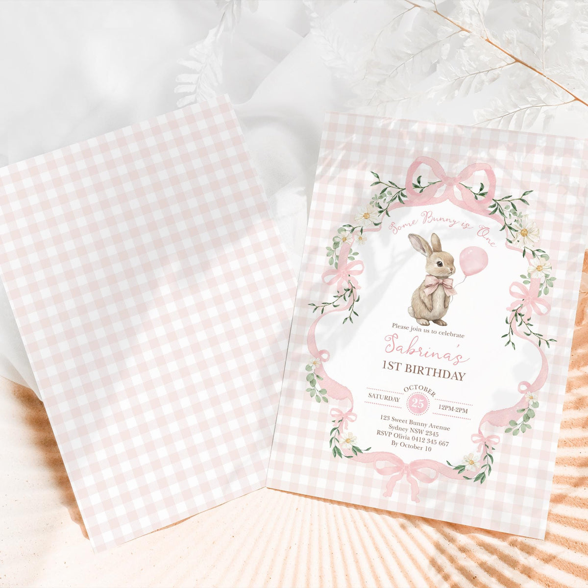 The invitation front beside its plain pink gingham back panel, which carries no wording