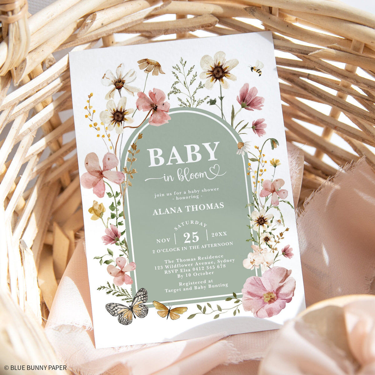 Invitation in a woven basket with dried pampas grass and soft light
